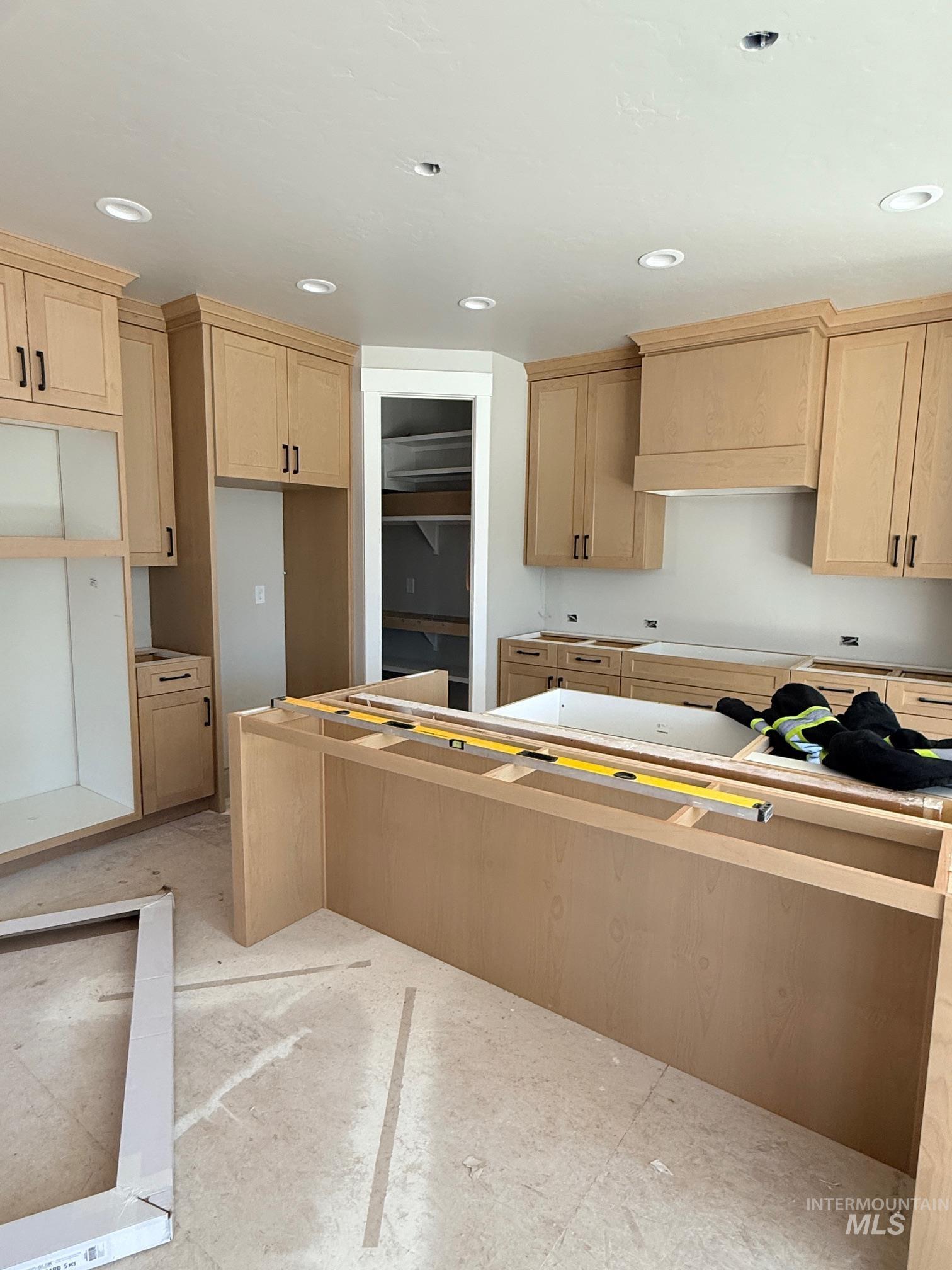 945 West Malbar Street Meridian, ID 83646 - Photo 3 of 37 Kitchen with light wood finish cabinets, recessed lighting, stovetop, and a kitchen island