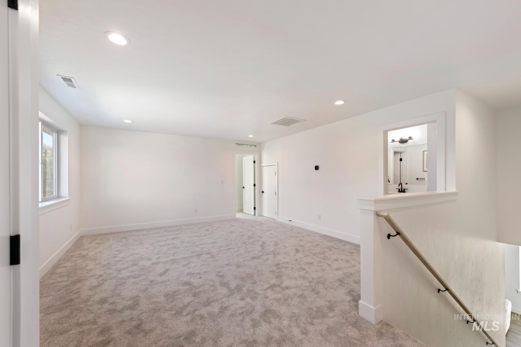 945 West Malbar Street Meridian, ID 83646 - Photo 33 of 42 Empty room featuring recessed lighting and light carpet