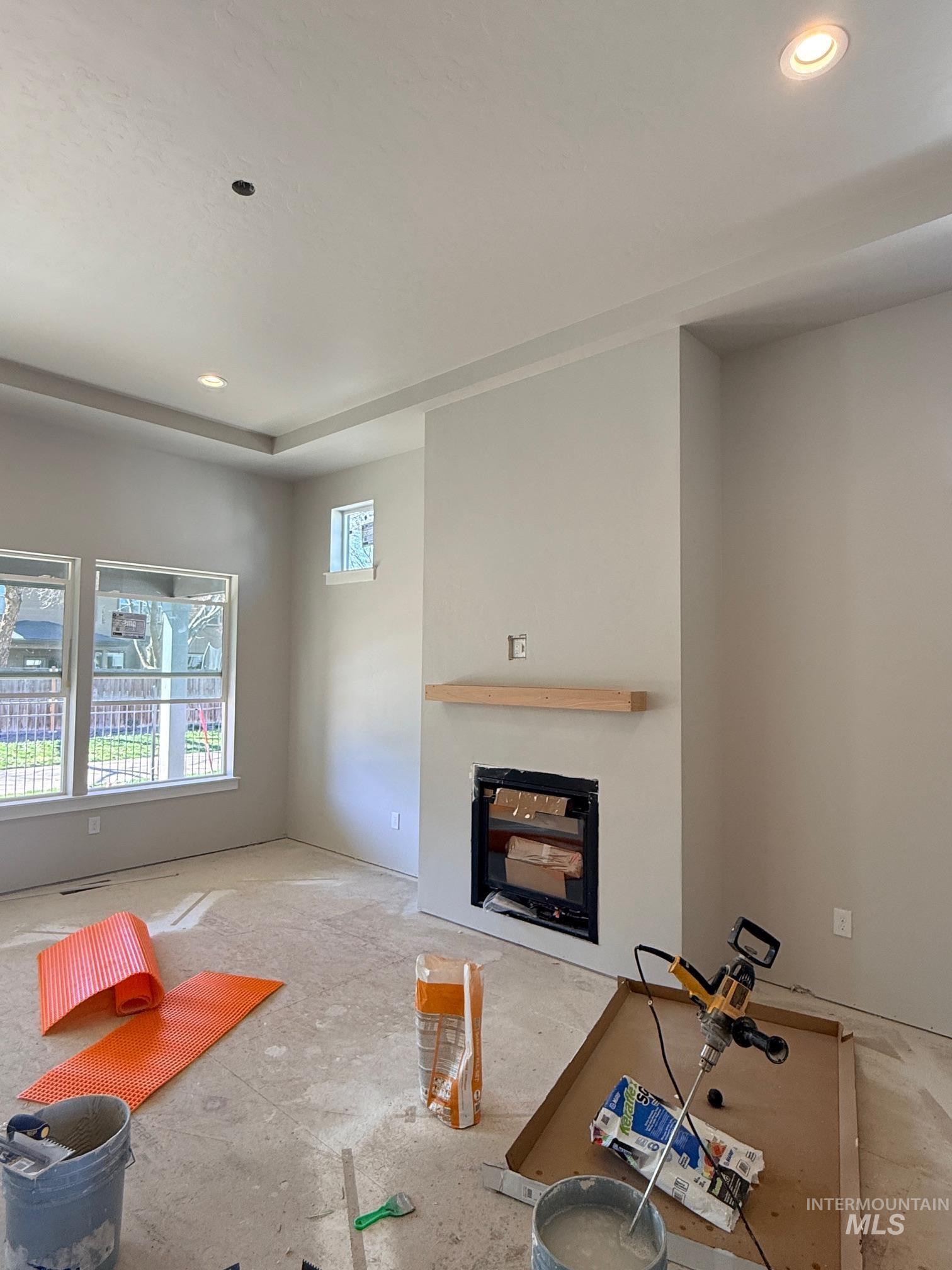 945 West Malbar Street Meridian, ID 83646 - Photo 4 of 37 Unfurnished living room with recessed lighting and a glass covered fireplace