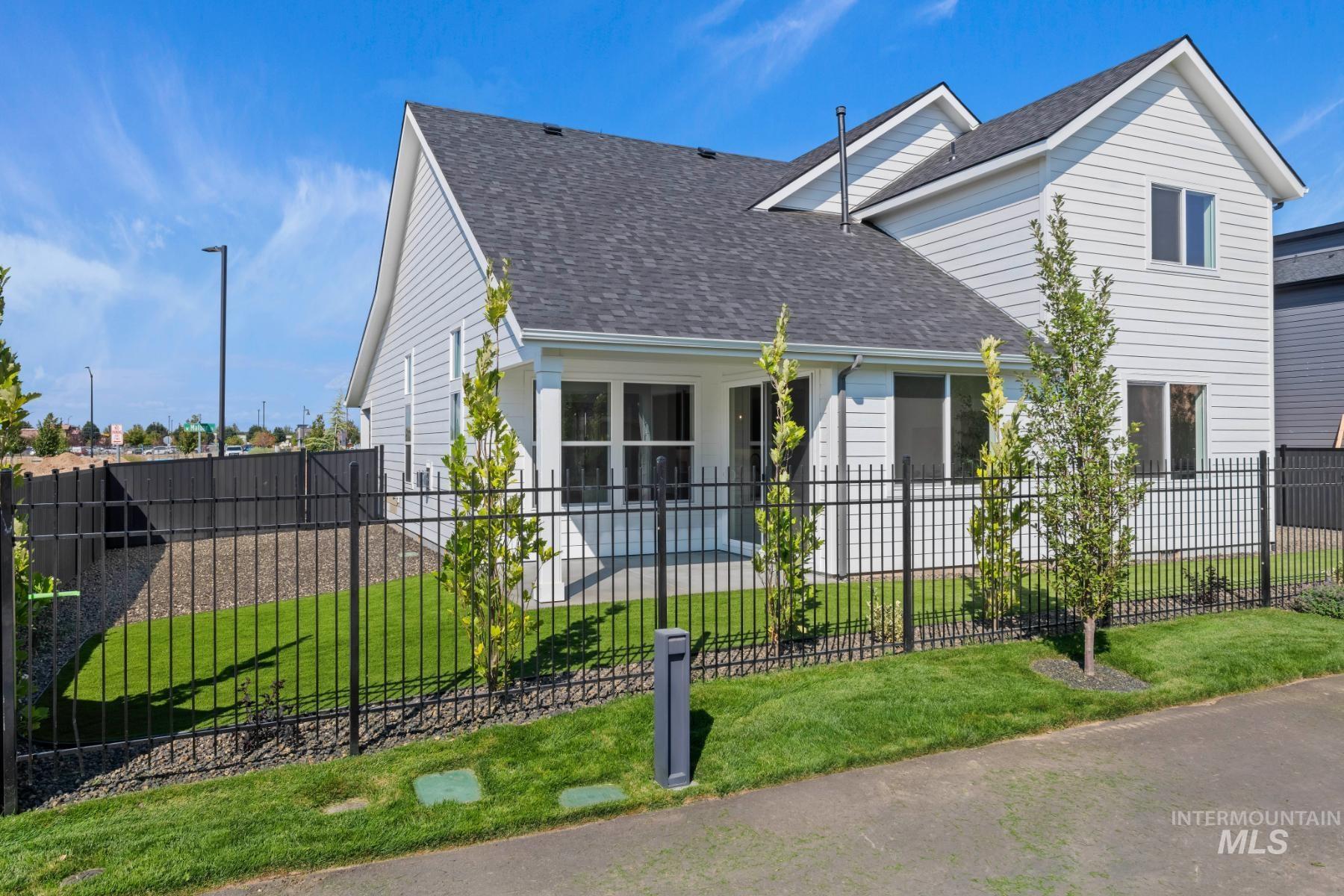 945 West Malbar Street Meridian, ID 83646 - Photo 40 of 42 View of front facade with a shingled roof, a fenced front yard, and a patio