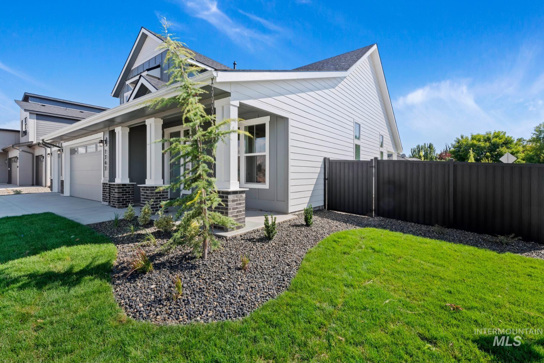 945 West Malbar Street Meridian, ID 83646 - Photo 5 of 42 View of side of property with covered porch, an attached garage, and driveway