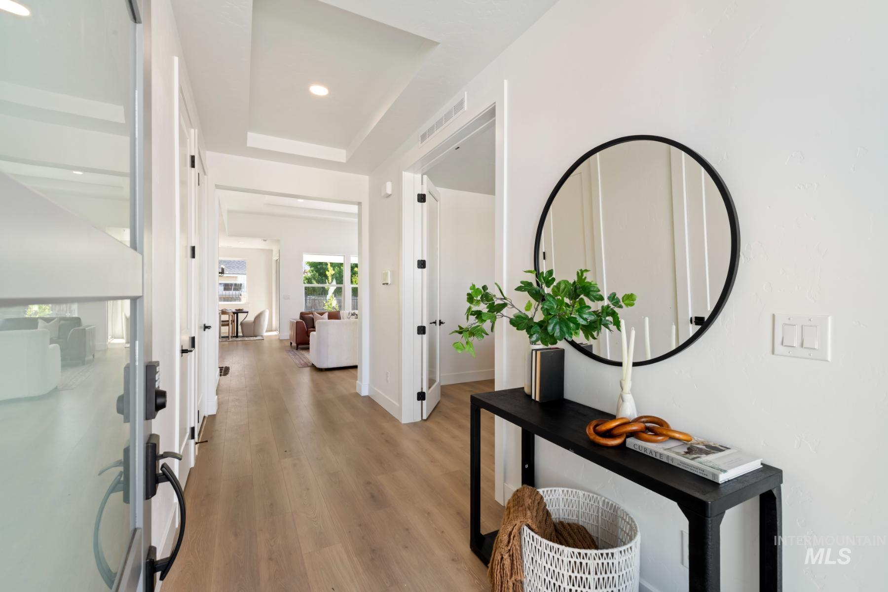 945 West Malbar Street Meridian, ID 83646 - Photo 7 of 42 Corridor featuring light wood-style floors, a tray ceiling, and recessed lighting