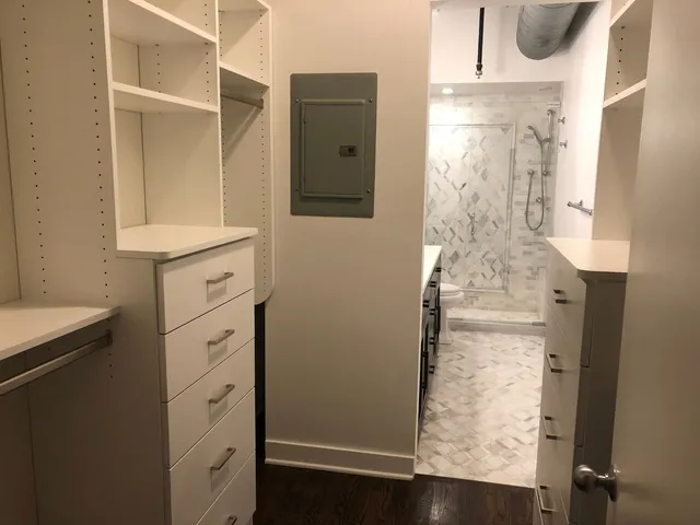 view of a bathroom with mirror on the shower and a window