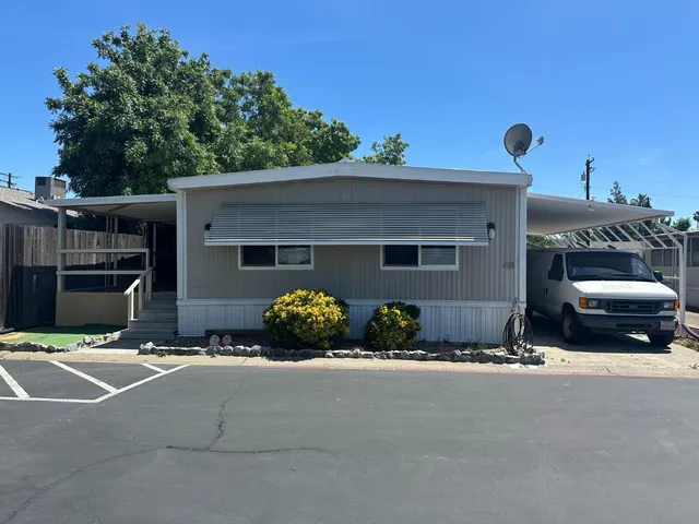 a couple of cars parked in front of a house