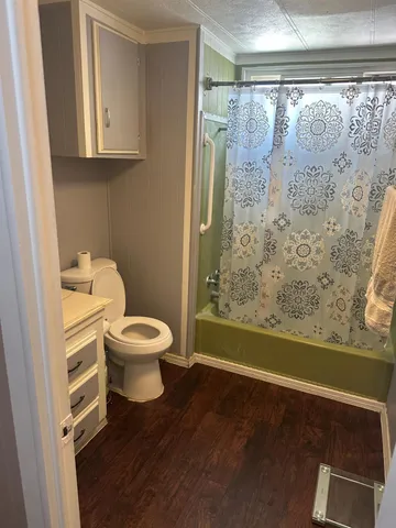a bathroom with a toilet and a shower