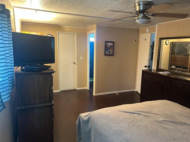 a bedroom with a bed and a flat screen tv