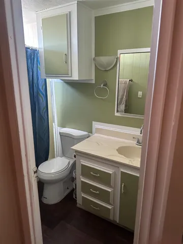 a bathroom with a toilet and a mirror