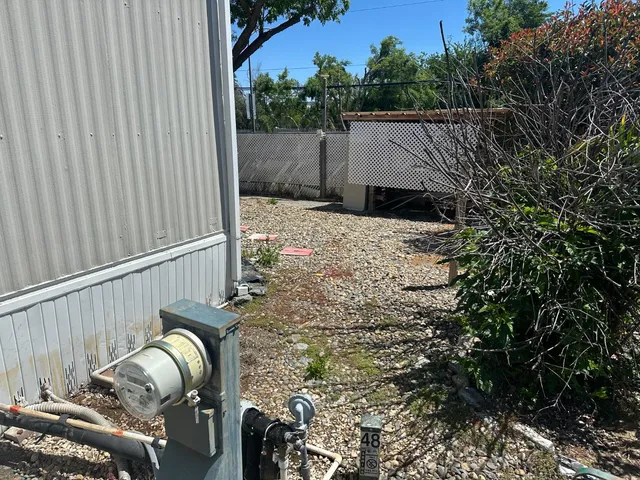 a view of a house with backyard and sitting area