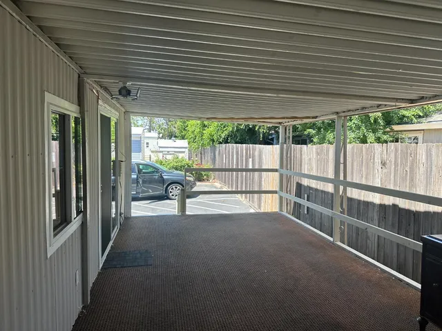 a view of a patio with table and chairs