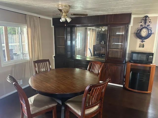a view of a dining room with furniture and window