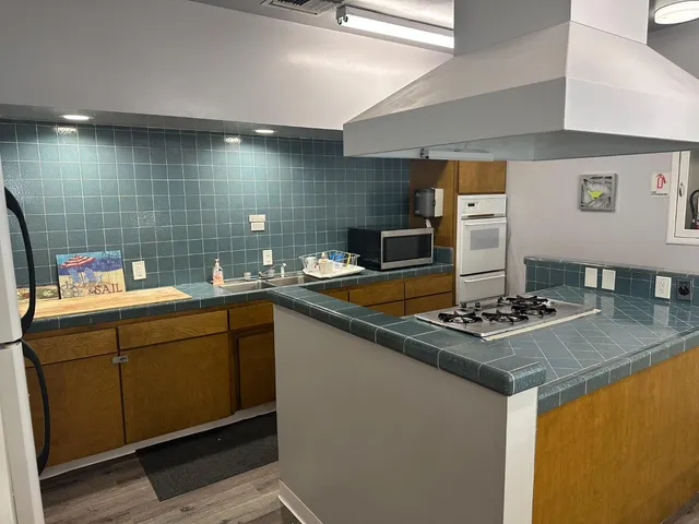 a kitchen with stainless steel appliances granite countertop a sink counter space and cabinets