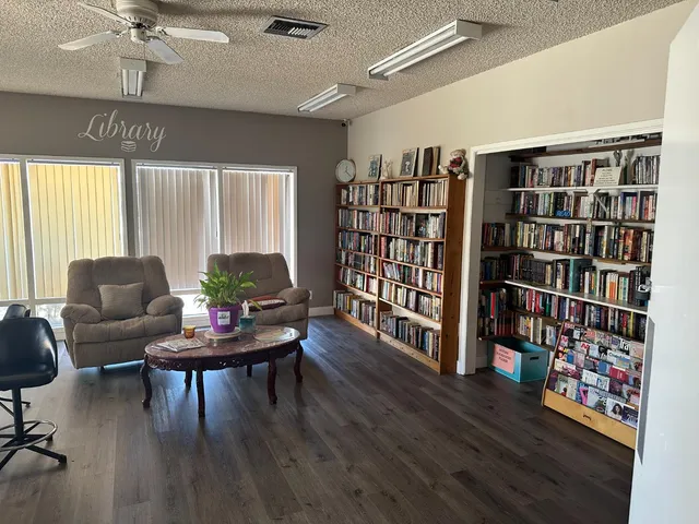 a living room with furniture a table and kitchen view