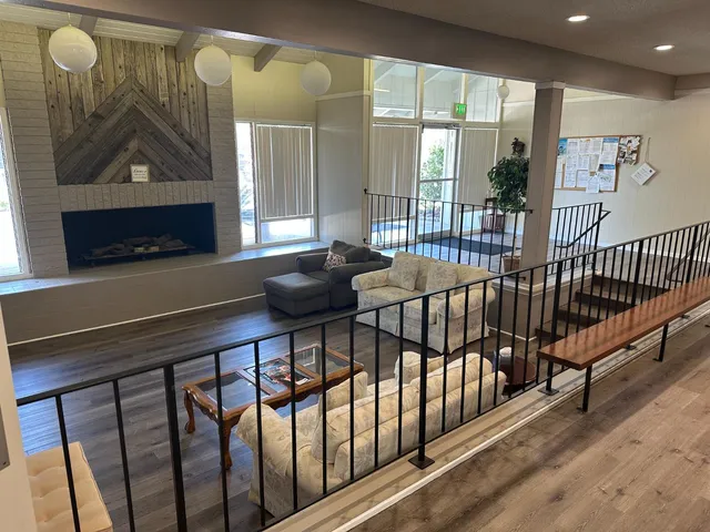a living room with kitchen furniture and a wooden floor
