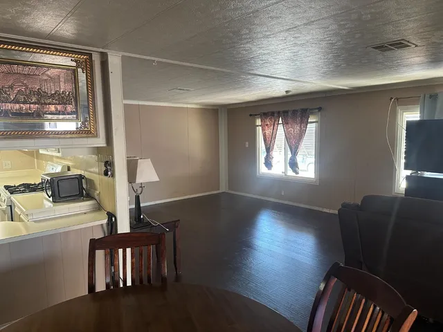 a view of a livingroom with furniture window and wooden floor