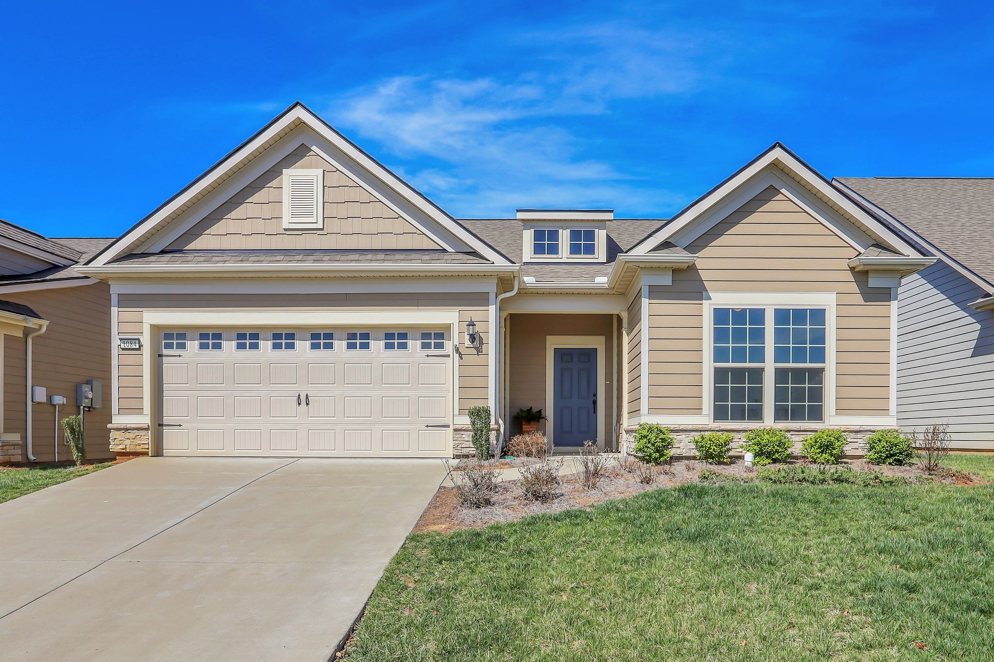 a front view of a house with a yard and garage