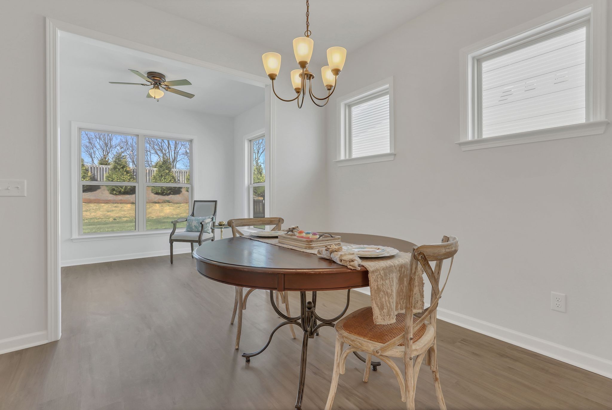 1084 Sumner Grove Spring Hill, TN 37174 - Photo 18 of 40 a view of a dining room with furniture a chandelier and wooden floor