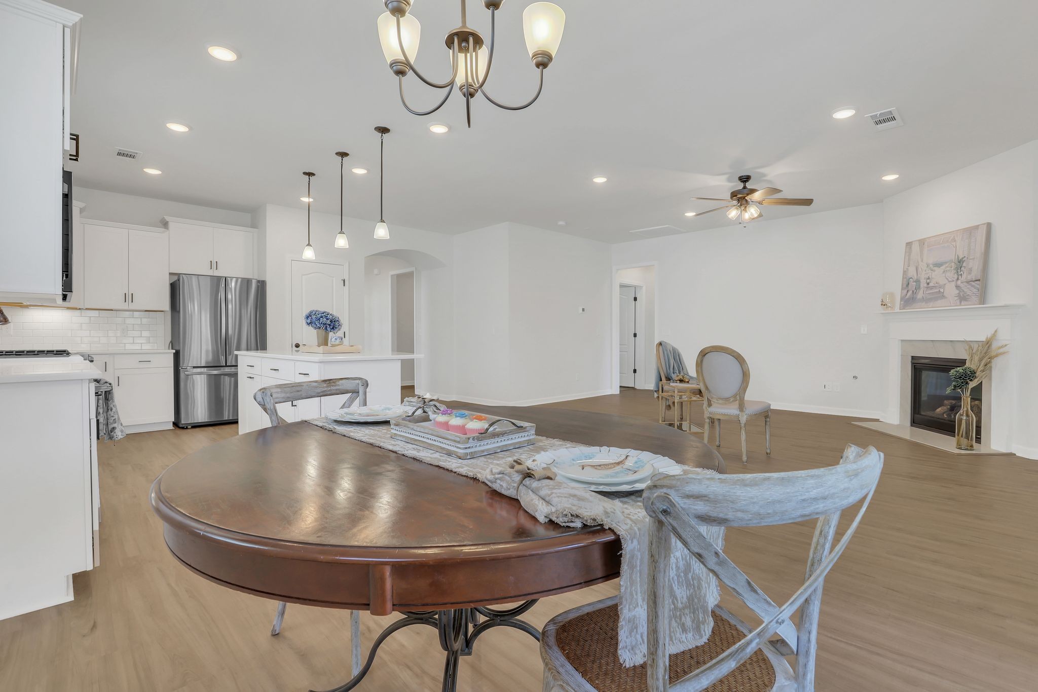 1084 Sumner Grove Spring Hill, TN 37174 - Photo 19 of 40 a kitchen with kitchen island a dining table chairs and a chandelier