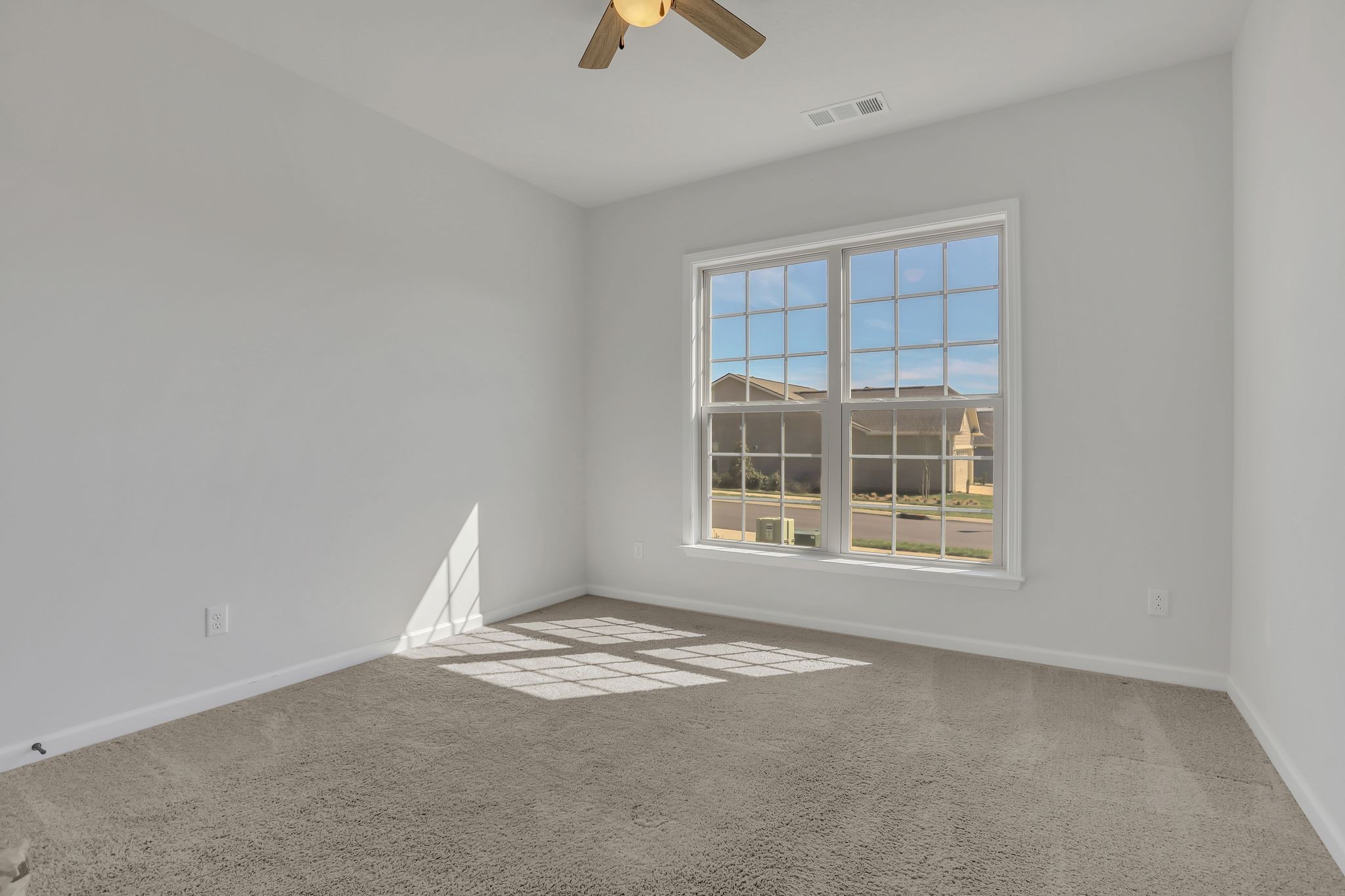 1084 Sumner Grove Spring Hill, TN 37174 - Photo 23 of 40 an empty room with chandelier fan and windows
