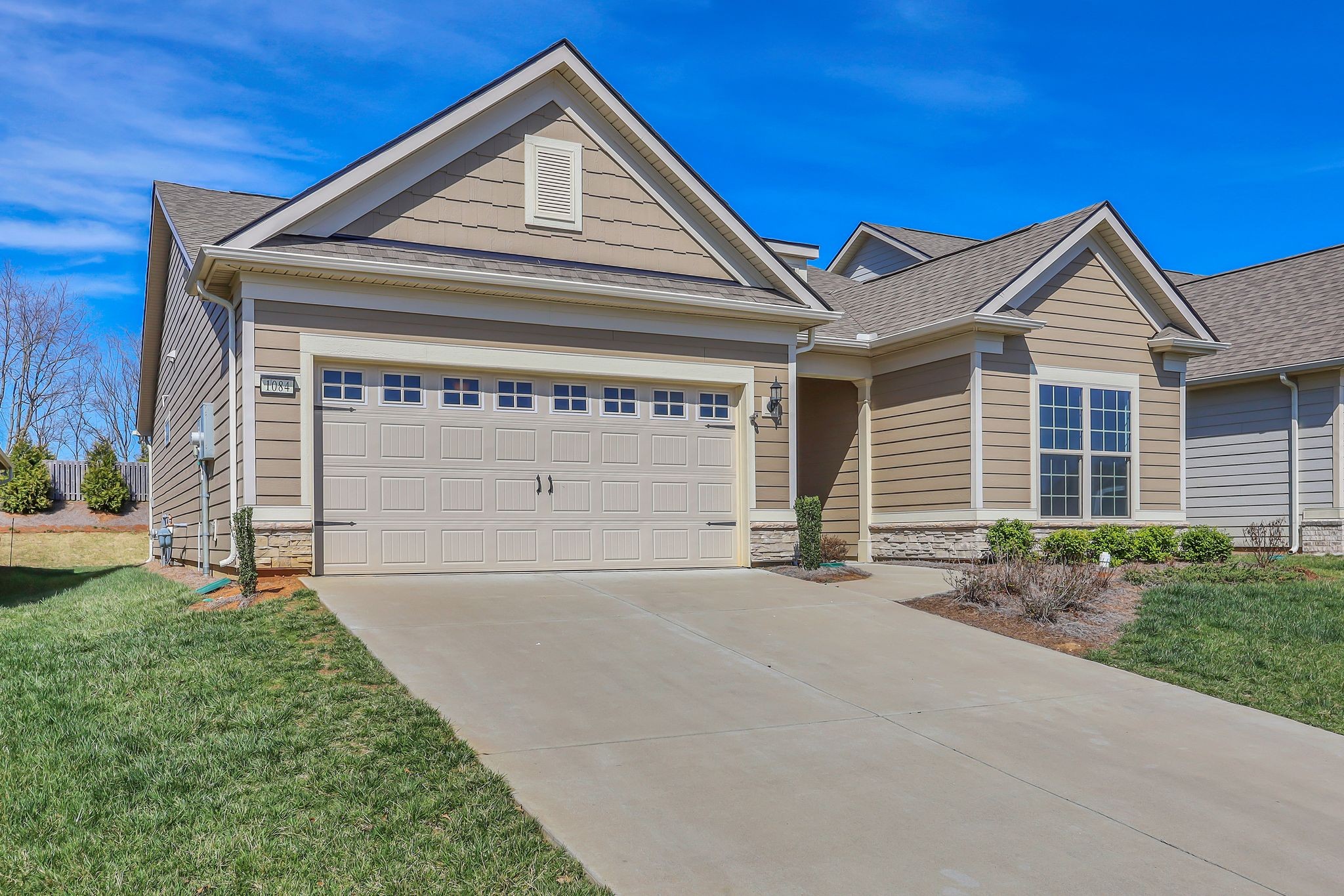 1084 Sumner Grove Spring Hill, TN 37174 - Photo 3 of 40 a front view of a house with a yard and garage