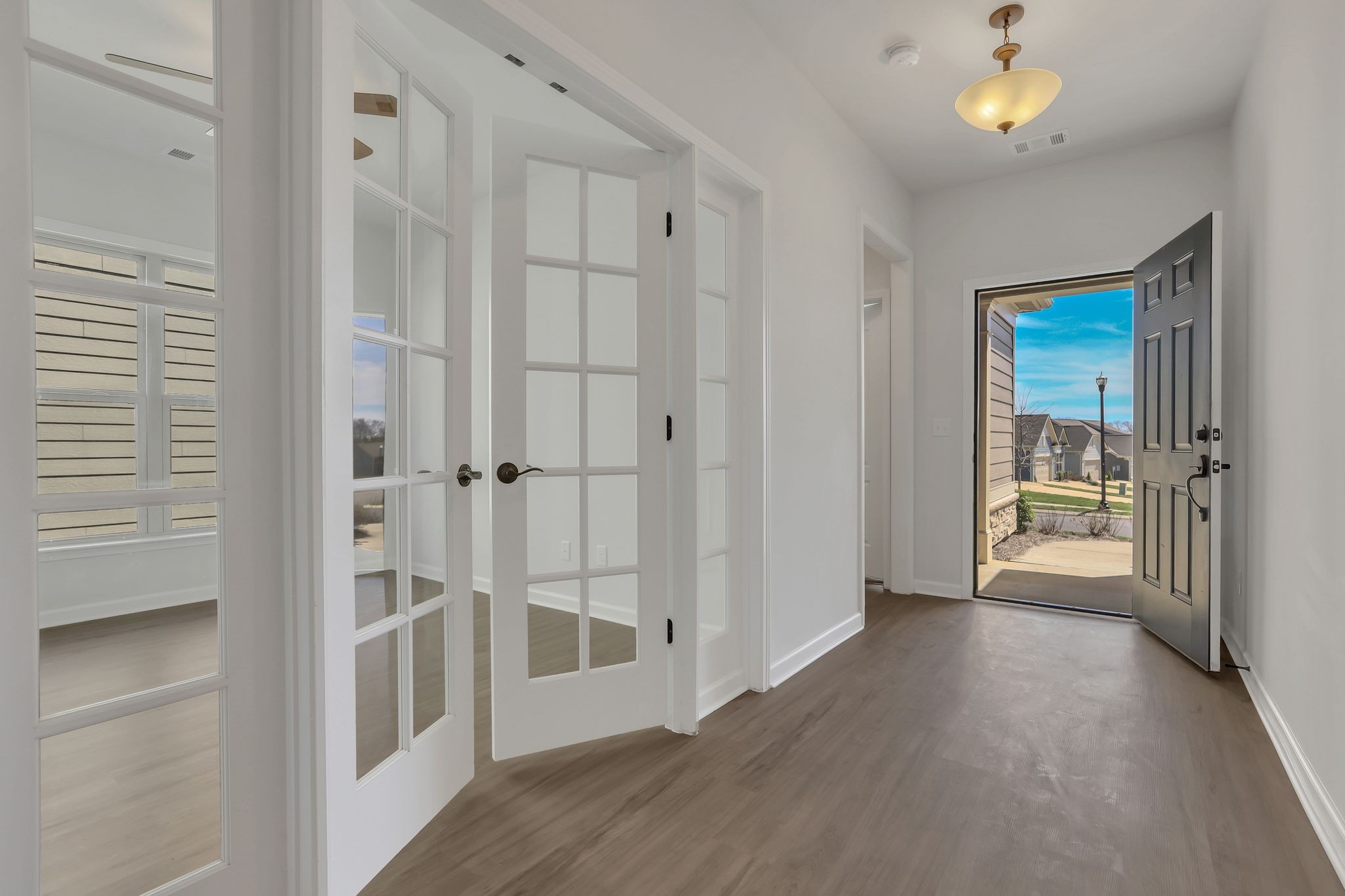 1084 Sumner Grove Spring Hill, TN 37174 - Photo 5 of 40 a view of a hallway with wooden floor and a cabinet