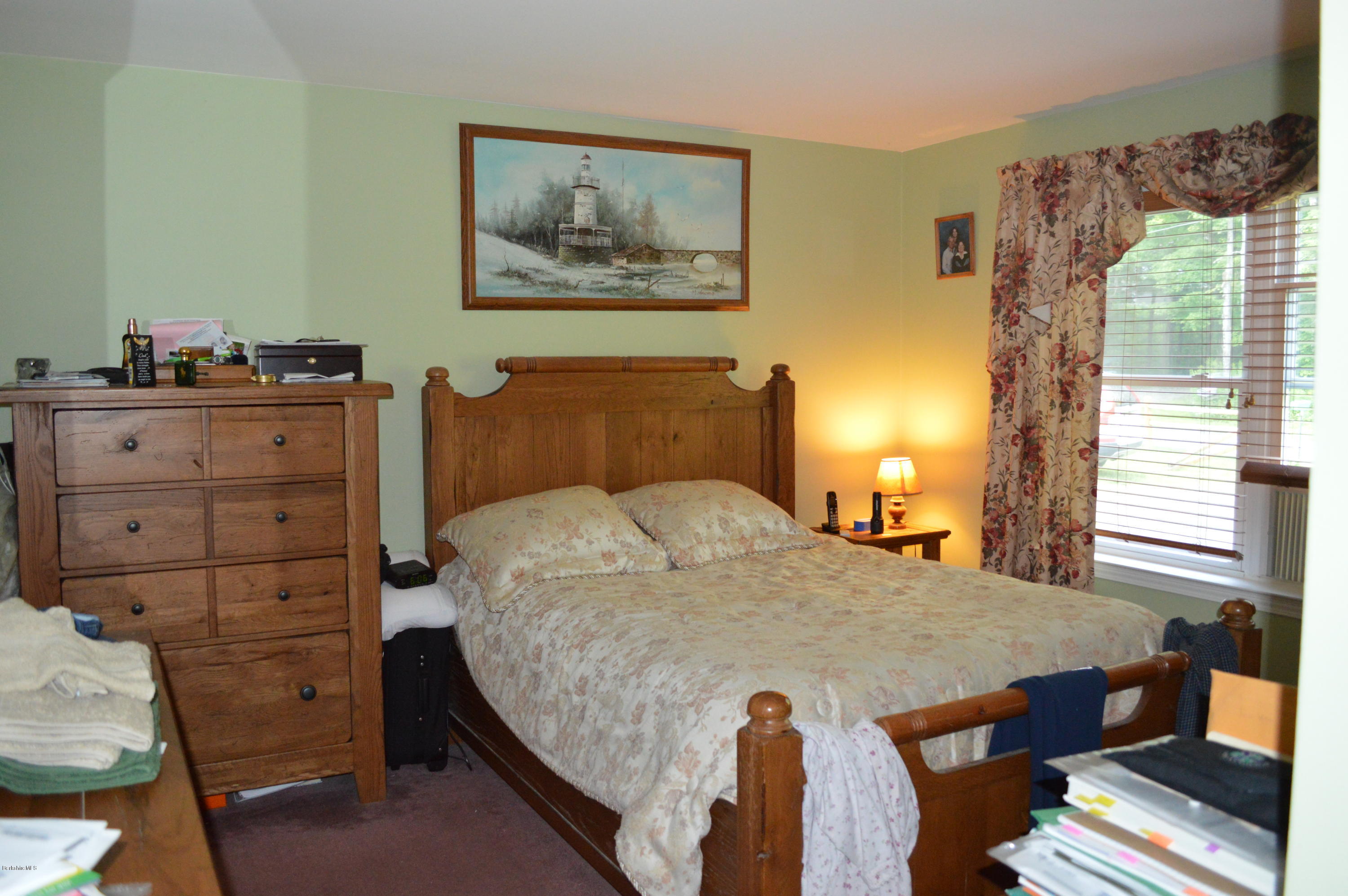 753 Upper Valley Road Washington, MA 01223 - Photo 18 of 32 a bedroom with a bed and wooden floor