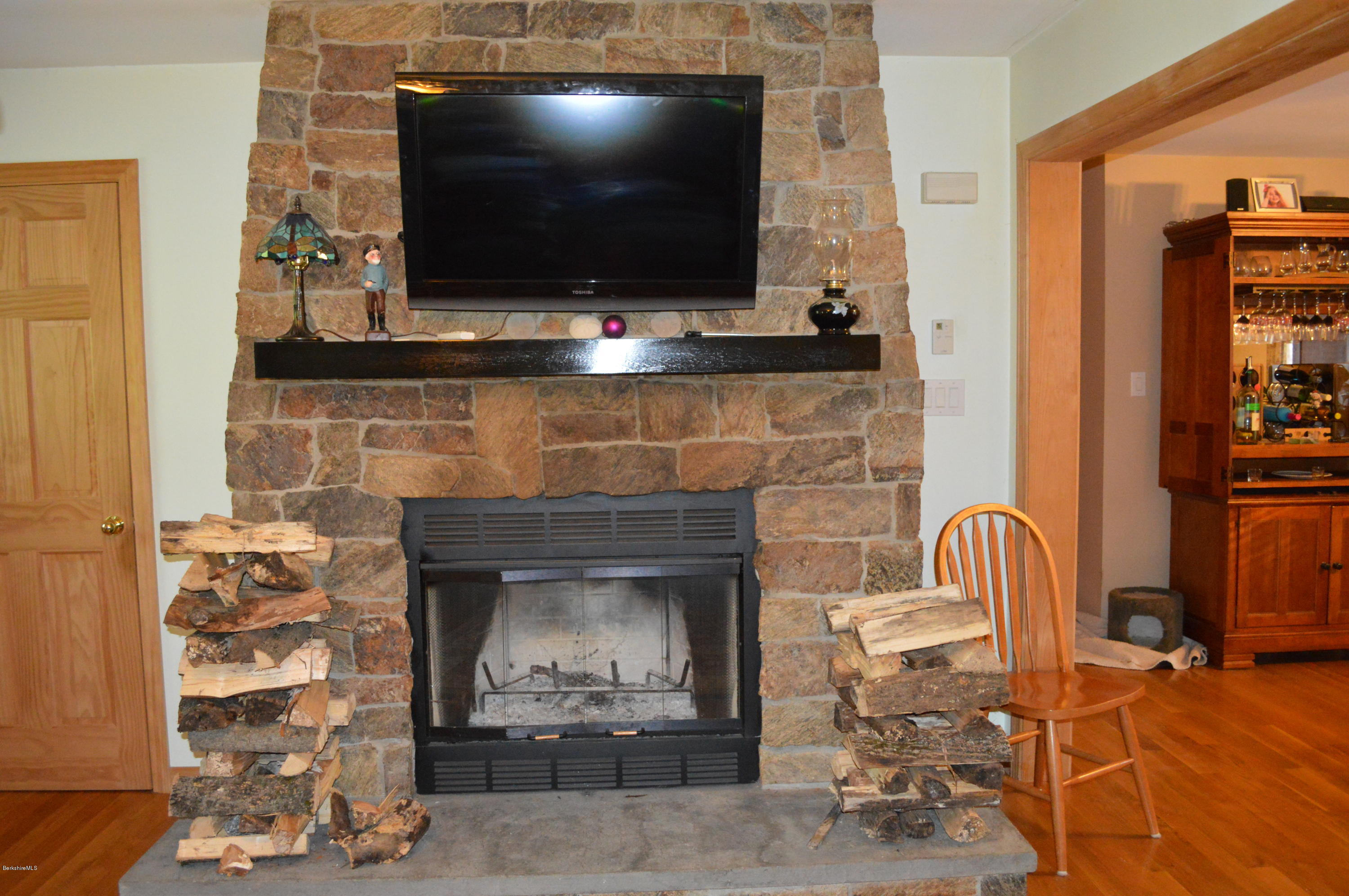 753 Upper Valley Road Washington, MA 01223 - Photo 27 of 32 a living room with fireplace furniture and a flat screen tv