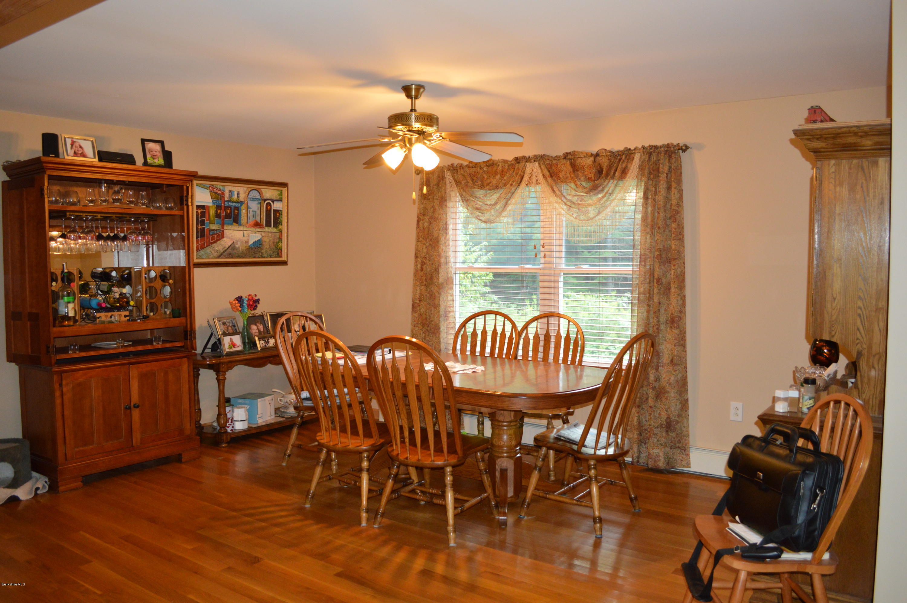 753 Upper Valley Road Washington, MA 01223 - Photo 28 of 32 a dining room with furniture a chandelier and wooden floor