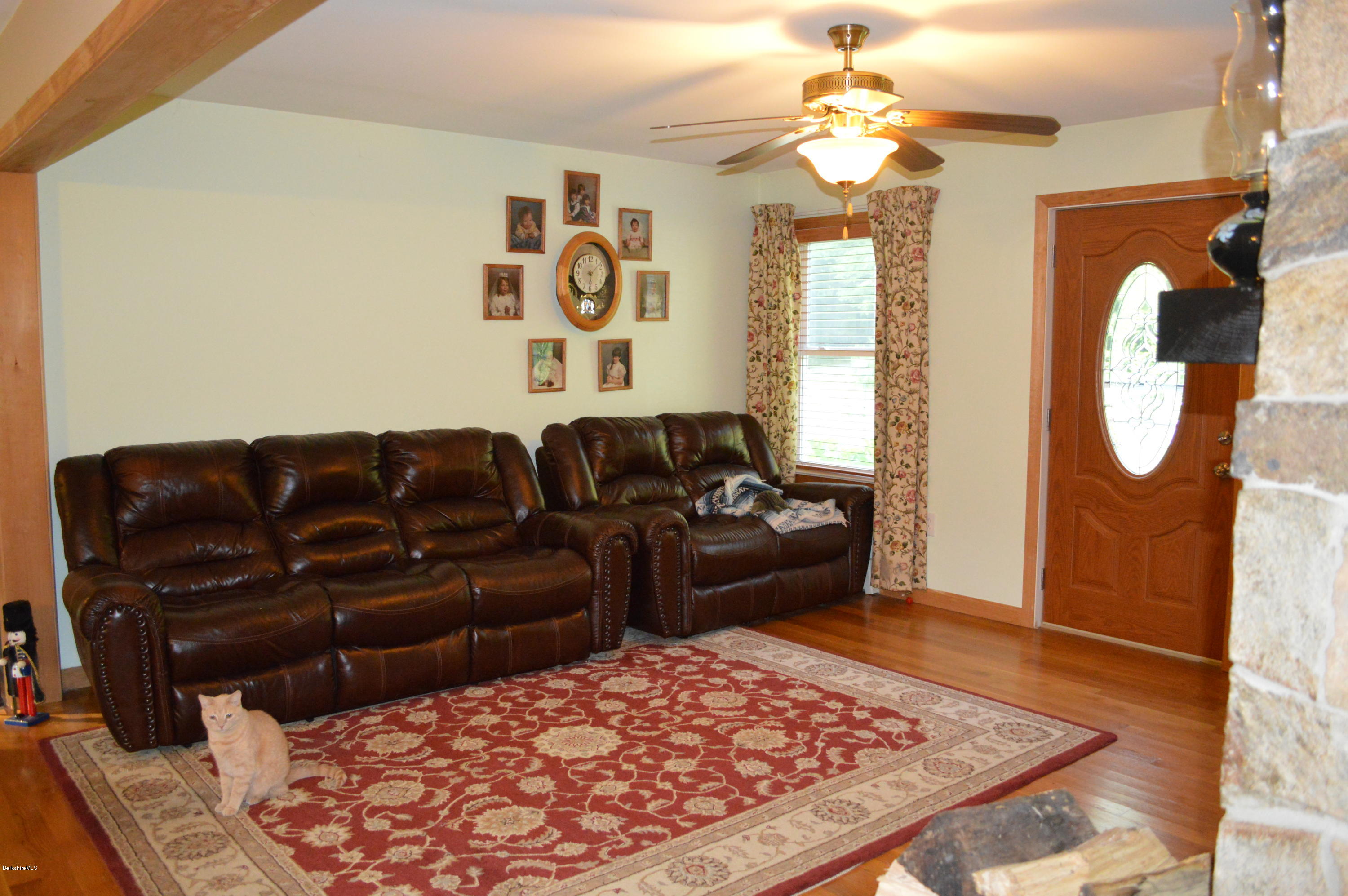 753 Upper Valley Road Washington, MA 01223 - Photo 32 of 32 a living room with a couch and a chandelier