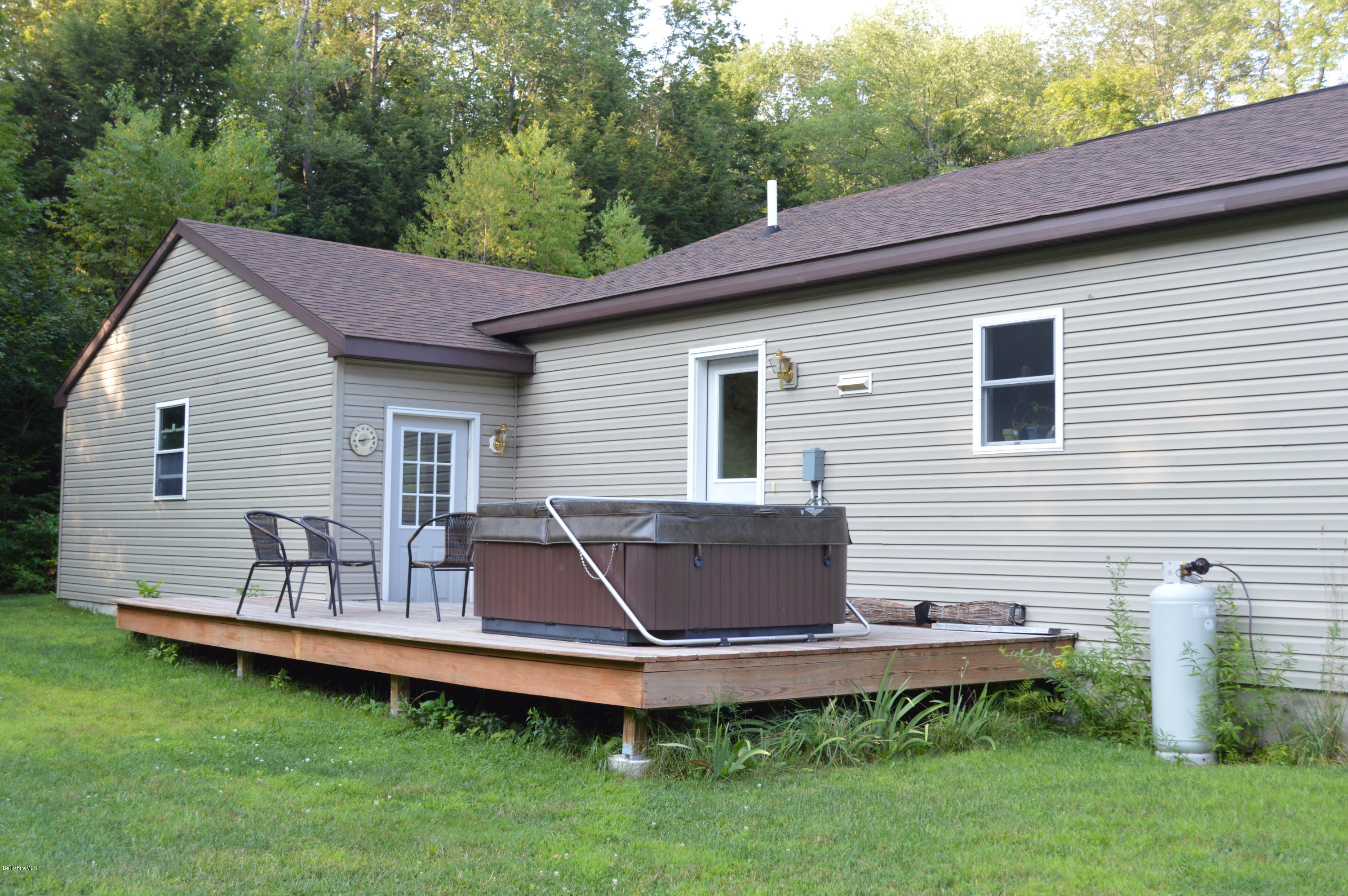 753 Upper Valley Road Washington, MA 01223 - Photo 8 of 32 a backyard of a house with wooden deck and barbeque oven