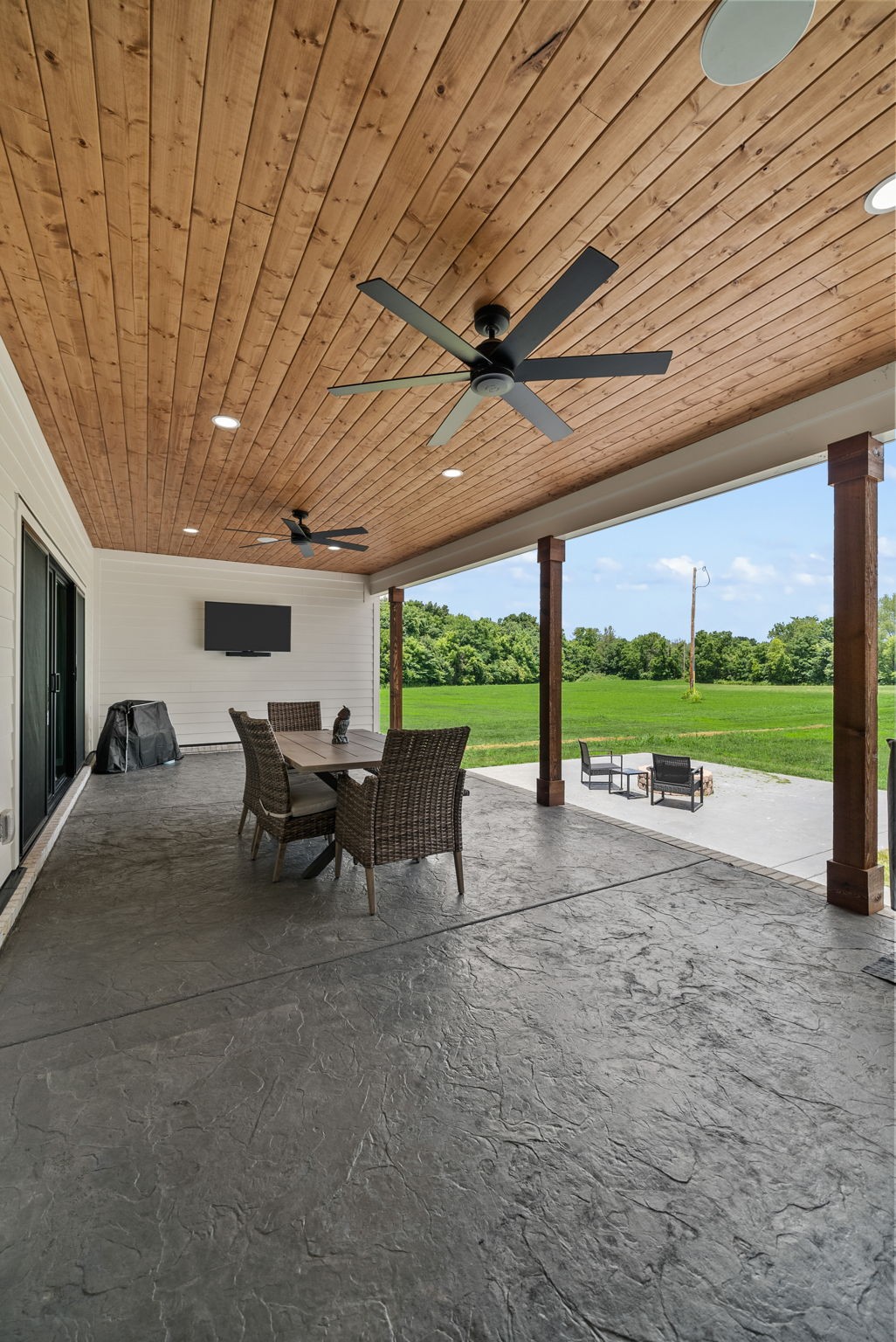 5183 Sango Road Clarksville, TN 37043 - Photo 18 of 84 a view of a patio with table and chairs and a large tree