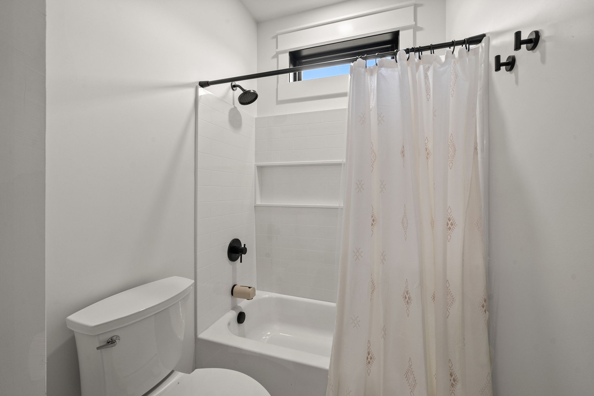 5183 Sango Road Clarksville, TN 37043 - Photo 60 of 84 a bathroom with a shower curtain and a toilet