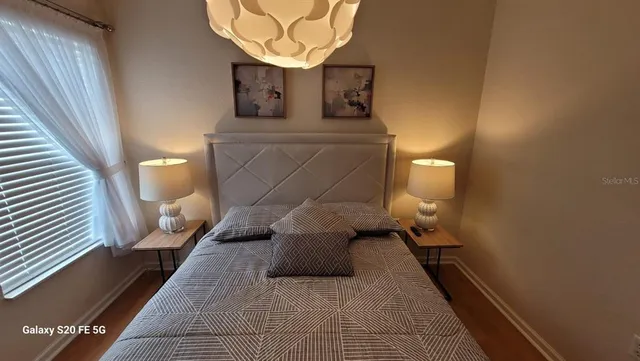 a bedroom with a bed and window