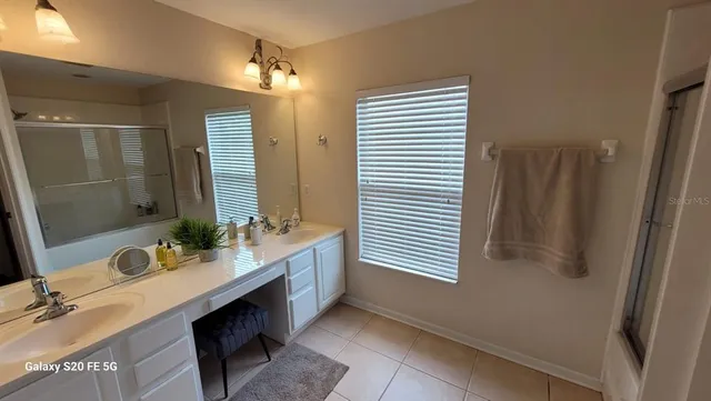 a bathroom with a sink double vanity and a mirror