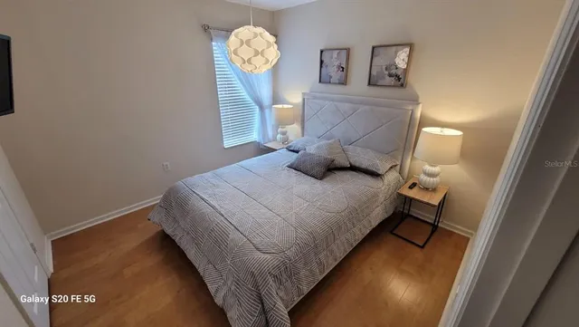 a bedroom with a bed and a window