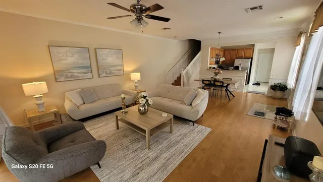 a living room with furniture and wooden floor