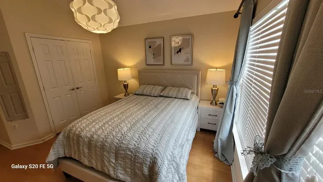 a bedroom with a bed and a chandelier