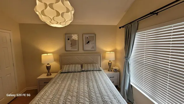 a bedroom with a bed and a chandelier