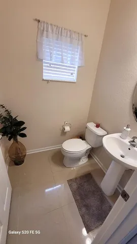 a bathroom with a toilet a sink and a mirror