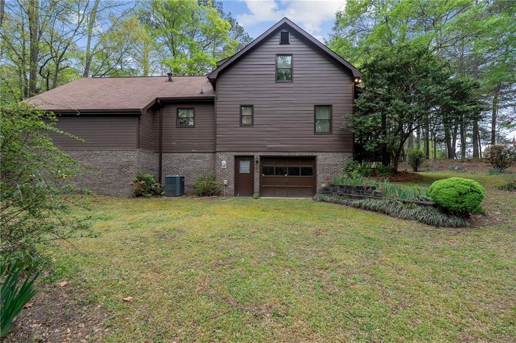 3121 Bonds Lake Road Northwest Conyers, GA 30012 - Photo 31 of 36 a view of a house with a yard plants and large tree
