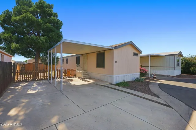 a view of a house with backyard and a tree