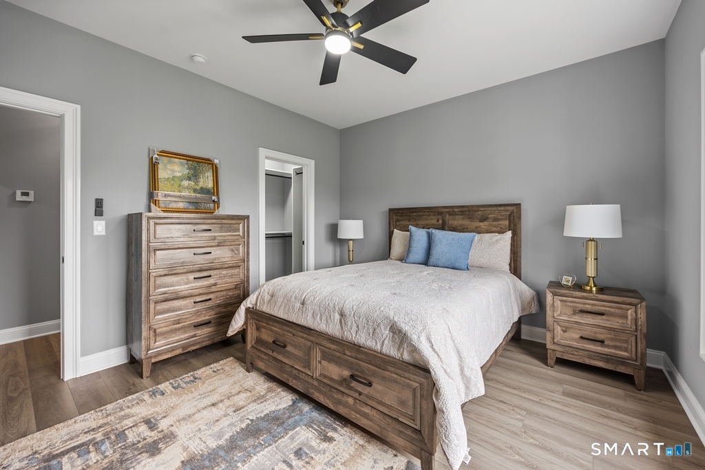 210 Munson Road, Unit 2G Wolcott, CT 06716 - Photo 13 of 23 a bedroom with a bed and wooden floor