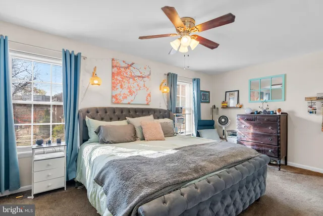 a bedroom with a large bed and a window