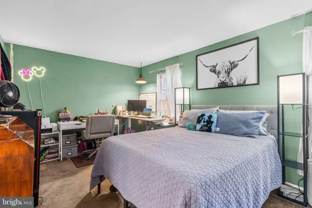 a bed room with two bed and paintings on the wall