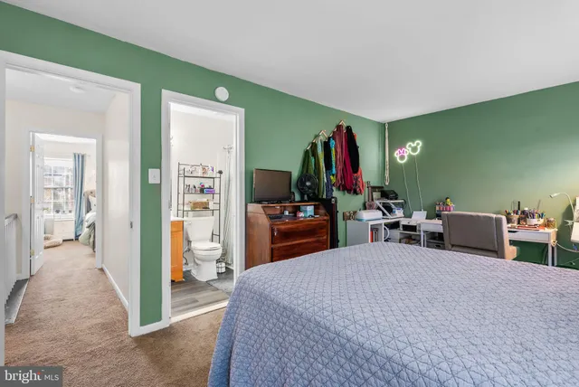 a bed room with furniture and a flat screen tv