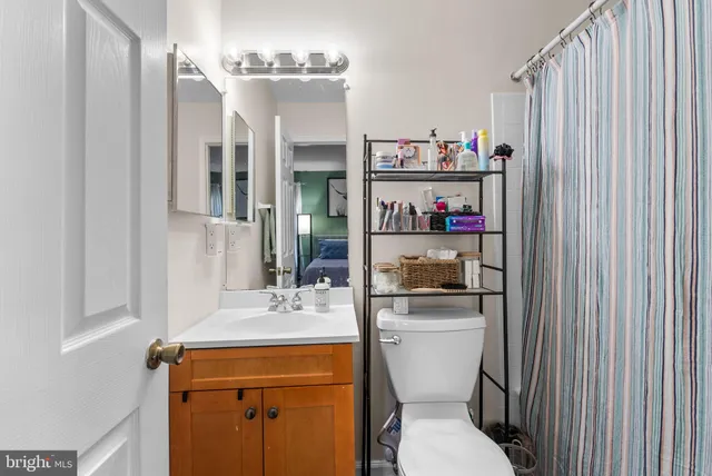 a bathroom with a sink a toilet and a mirror