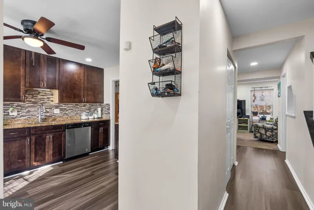 a kitchen with stainless steel appliances kitchen island granite countertop a refrigerator and a sink