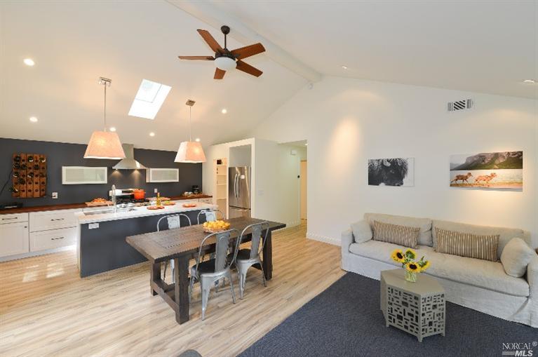 a living room with furniture and kitchen view