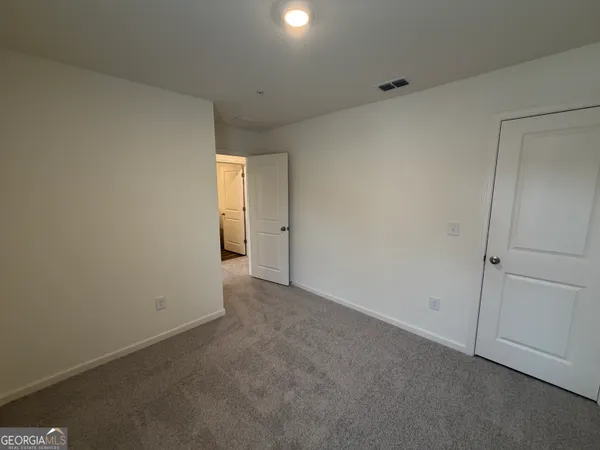 a view of an empty room and a window