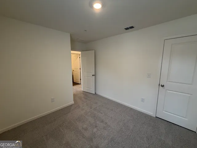 a view of an empty room and a window