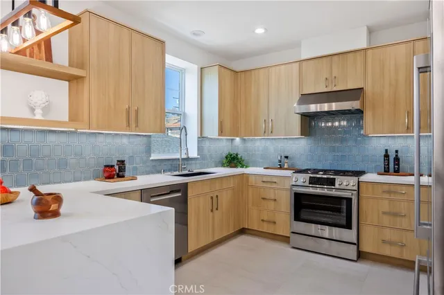 a kitchen with a stove sink and refrigerator